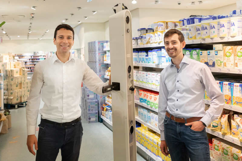 Georg Bartels (left) and Jonas Reiling, Managing Directors at Ubica Robotics, demonstrate their scanning robot in a branch of a chemists chain in Bremen.