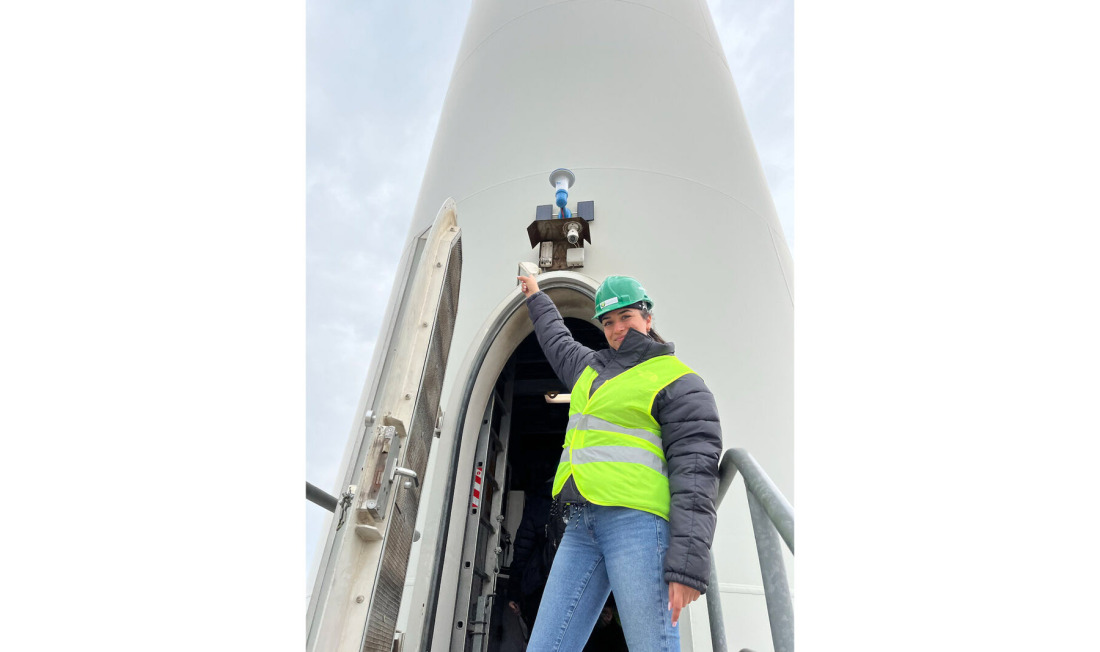 Woman in front of a wind turbine
