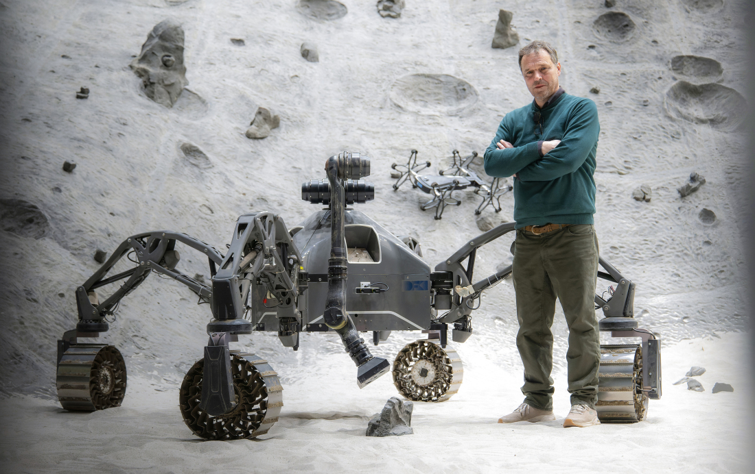 The Managing Director of the German Research Center for Artificial Intelligence, Frank Kirchner, with a space robot.