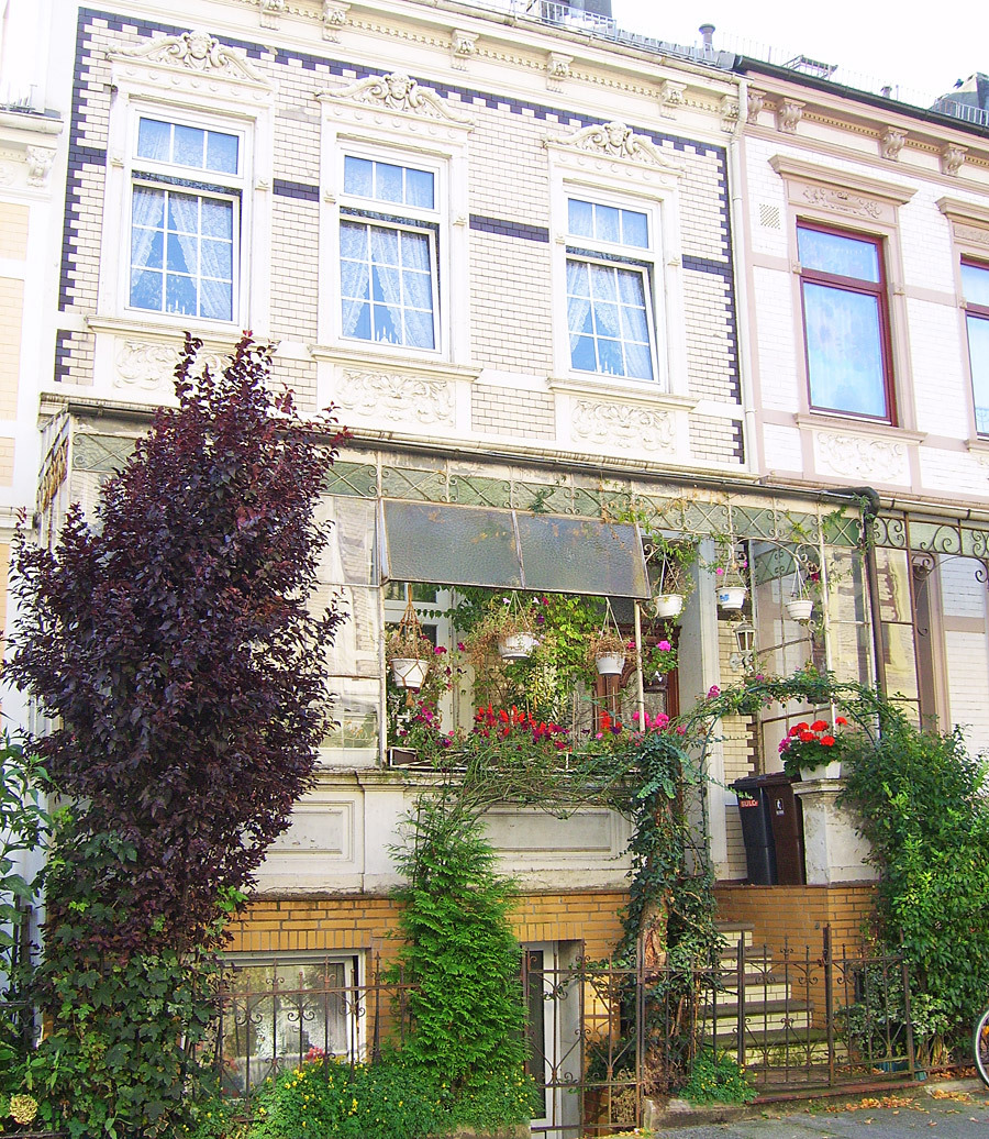 Old Bremen row house with flowers on veranda